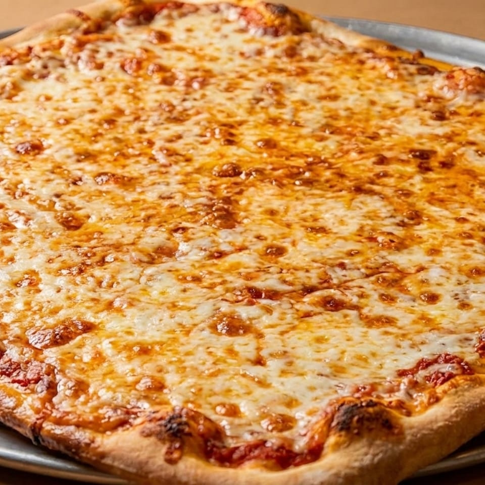 A large, square cheese pizza with a golden-brown crust sits on a metal tray.